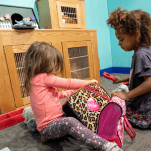 two girls play with the veterinary clinic at our old caroline street location.